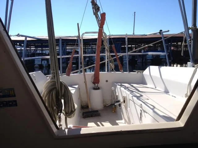Slide: The Image of 1981 CAL 25II Mk II sailboat cockpit with ropes and marina view. - 6
