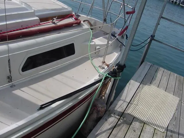 Slide: The Image of 1981 CAL 25II Mk II sailboat docked at a marina with blue water. - 9