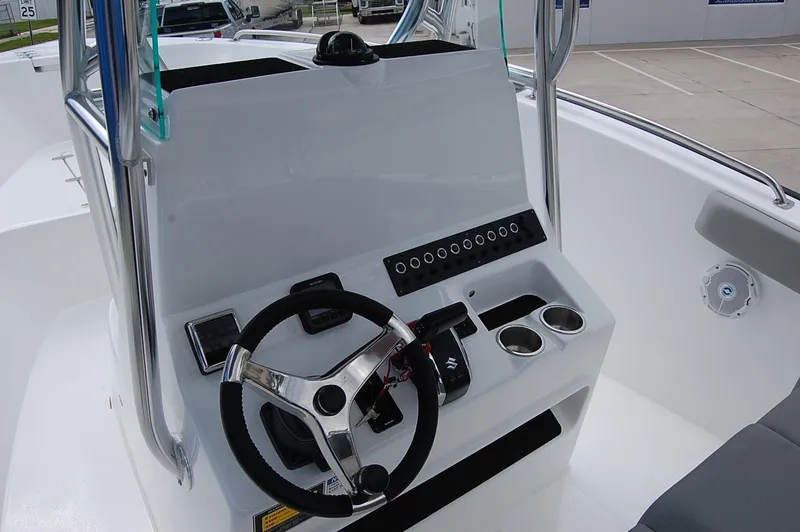 Slide: The Image of 2025 Cape Horn 22 OS boat console with steering wheel and controls. - 3