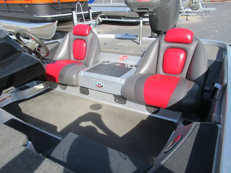 Slide: The Image of 2014 Ranger Z118C boat interior with red and gray seats, steering wheel, and console. - 3