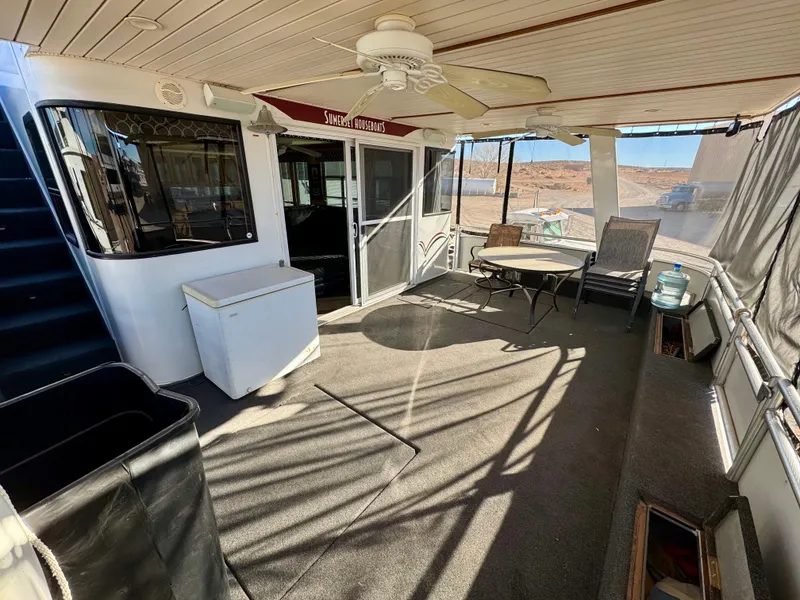Slide: The Image of 2006 Sumerset Seas The Day Share 7 houseboat interior with seating and ceiling fan. - 32