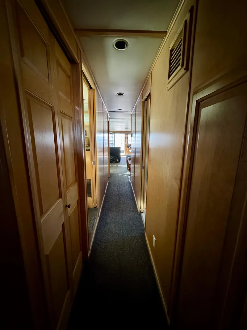 Slide: The Image of Narrow hallway inside 2006 Sumerset Seas The Day Share 7 houseboat, featuring wooden paneling. - 40