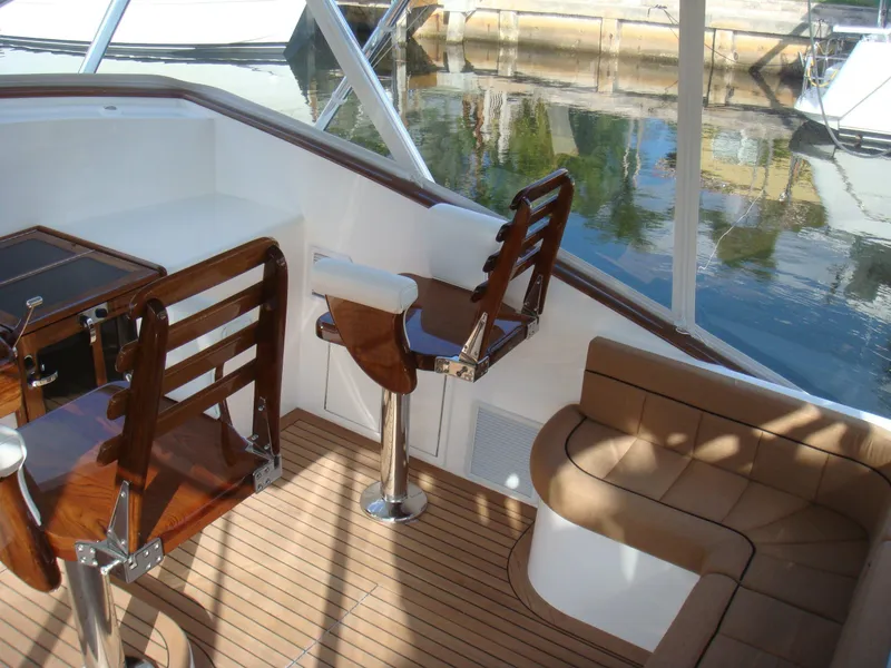 Slide: The Image of 2024 Jersey Cape Devil 45-Express Custom boat interior with wooden seating and helm station. - 15