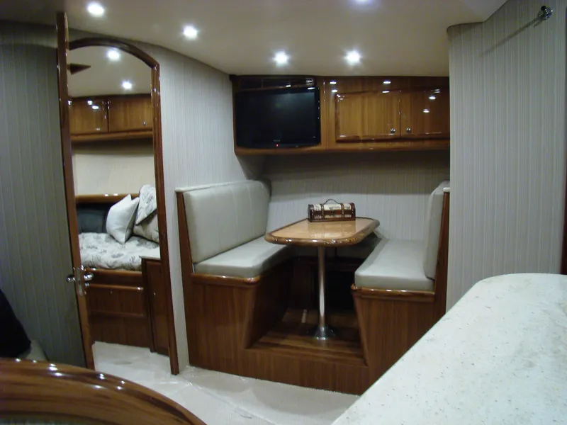 Slide: The Image of 2024 Jersey Cape Devil 45-Express Custom interior with dining area and TV. - 18