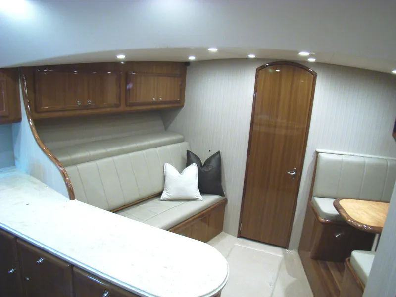 Slide: The Image of 2024 Jersey Cape Devil 45-Express Custom interior with seating, cabinets, and dining area. - 23