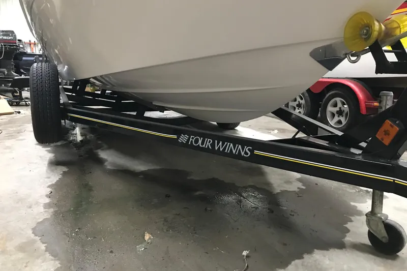 Slide: The Image of 2005 Four Winns 190 Horizon boat on trailer in garage setting. - 10