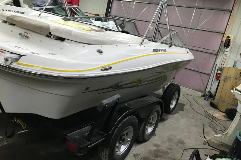 Slide: The Image of 2005 Four Winns 190 Horizon boat on trailer in garage setting. - 12