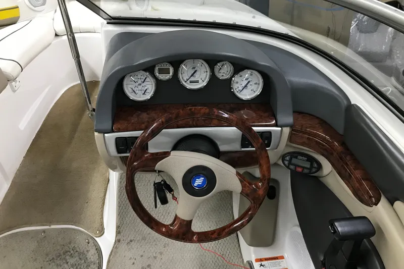 Slide: The Image of 2005 Four Winns 190 Horizon boat dashboard with wood accents and instrument gauges. - 17