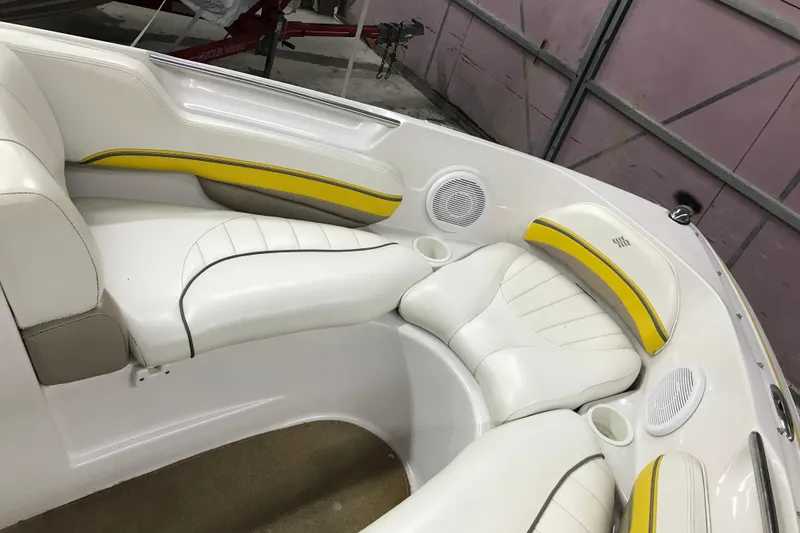 Slide: The Image of Interior of a 2005 Four Winns 190 Horizon boat with white and yellow seating. - 19