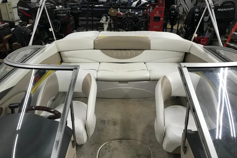 Slide: The Image of 2005 Four Winns 190 Horizon boat interior with white seating and dual consoles. - 20