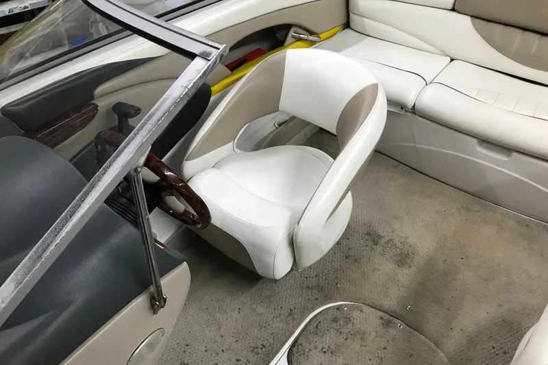 Slide: The Image of Interior of a 2005 Four Winns 190 Horizon boat with white seating and steering wheel. - 22
