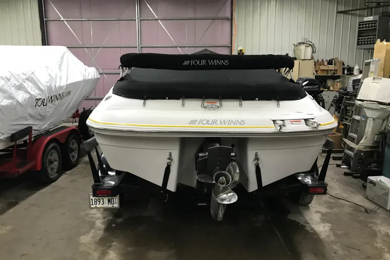 Slide: The Image of 2005 Four Winns 190 Horizon boat in garage, covered and on trailer. - 27