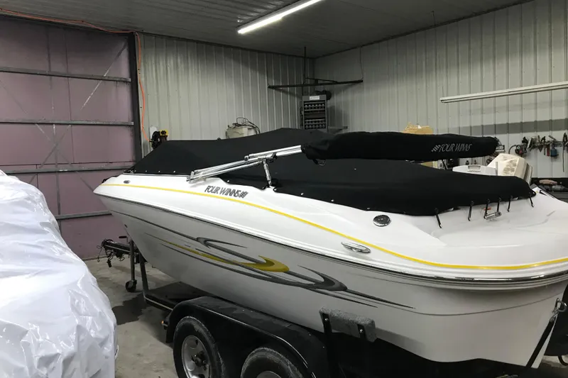Slide: The Image of 2005 Four Winns 190 Horizon boat in garage, covered and on trailer. - 28