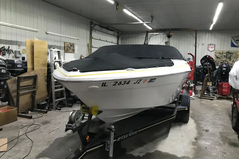 Slide: The Image of 2005 Four Winns 190 Horizon boat in garage, covered and on trailer. - 29
