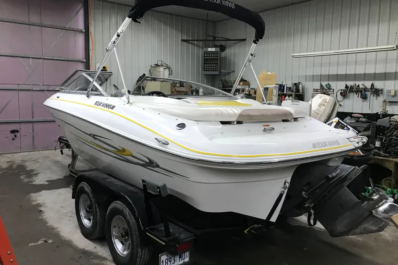 Slide: The Image of 2005 Four Winns 190 Horizon boat in garage, on trailer, with yellow accents. - 7