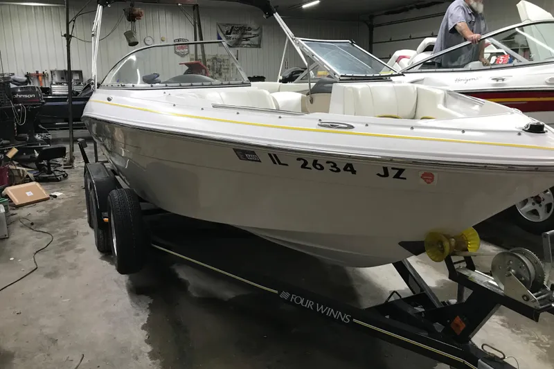 Slide: The Image of 2005 Four Winns 190 Horizon boat on trailer in garage setting. - 9