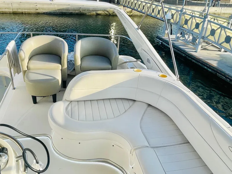 Slide: The Image of 1998 Maxum 4100 SCA yacht with elegant seating, docked by the water. - 10