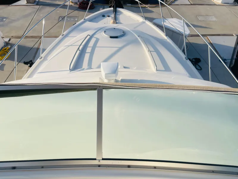 Slide: The Image of 1998 Maxum 4100 SCA yacht deck view with sleek design and railing. - 11