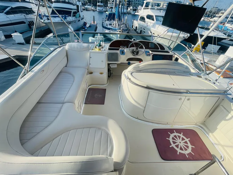Slide: The Image of Luxurious 1998 Maxum 4100 SCA yacht interior with white seating and marina view. - 13
