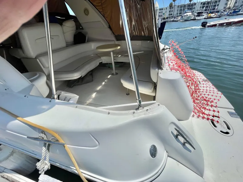 Slide: The Image of 1998 Maxum 4100 SCA yacht interior with seating, docked in marina. - 14