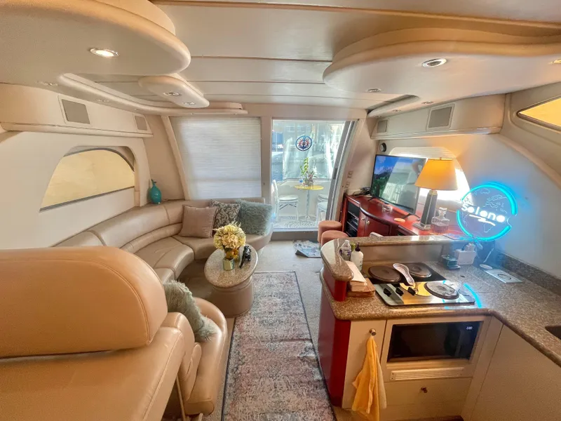 Slide: The Image of Luxurious interior of a 1998 Maxum 4100 SCA yacht with modern amenities and cozy seating. - 16