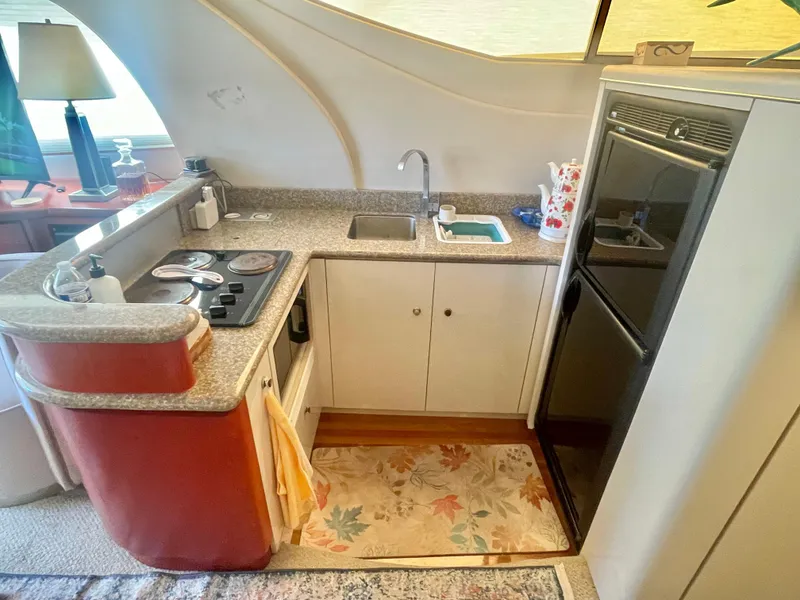 Slide: The Image of 1998 Maxum 4100 SCA yacht kitchen with stove, sink, and refrigerator. - 22