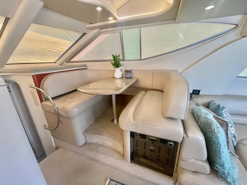 Slide: The Image of Luxurious 1998 Maxum 4100 SCA yacht interior with elegant seating and table. - 23