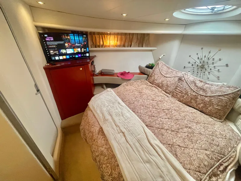 Slide: The Image of Luxurious bedroom in a 1998 Maxum 4100 SCA yacht with TV and elegant decor. - 27