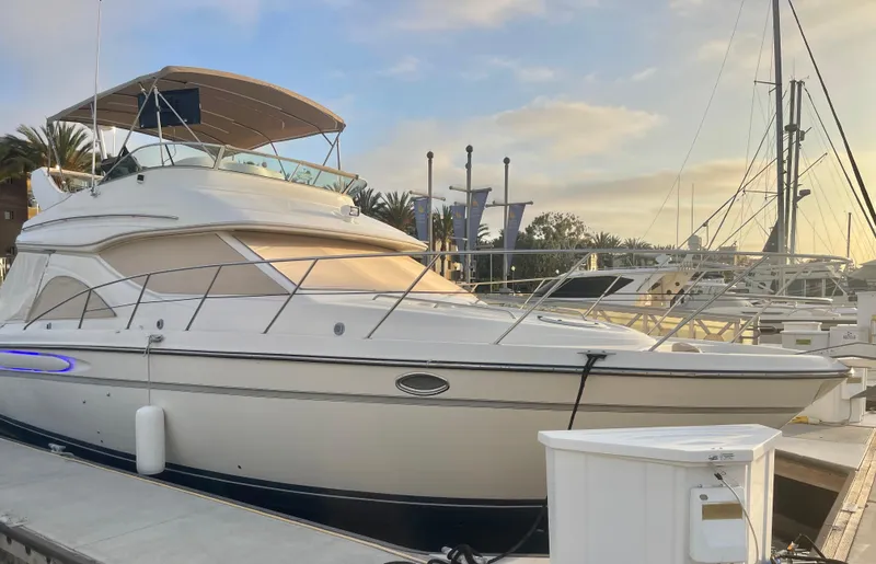 Slide: The Image of 1998 Maxum 4100 SCA yacht docked at marina during sunset. - 3