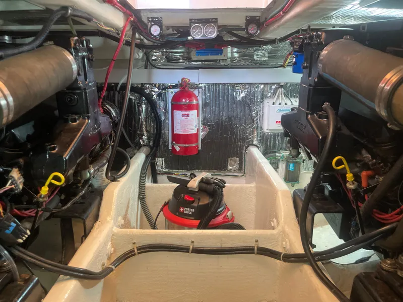 Slide: The Image of Engine room of 1998 Maxum 4100 SCA yacht with fire extinguisher and equipment. - 31
