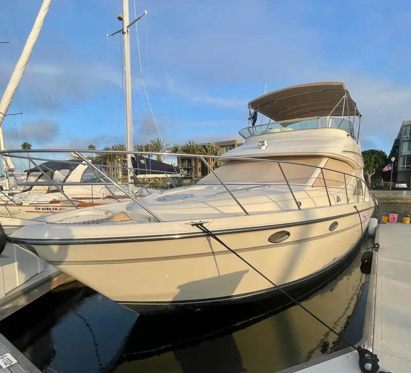 Slide: The Image of 1998 Maxum 4100 SCA yacht docked at marina under clear sky. - 4