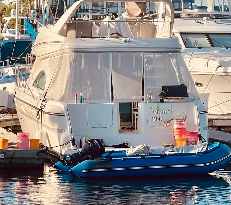 Slide: The Image of 1998 Maxum 4100 SCA yacht docked with inflatable boat and supplies. - 6