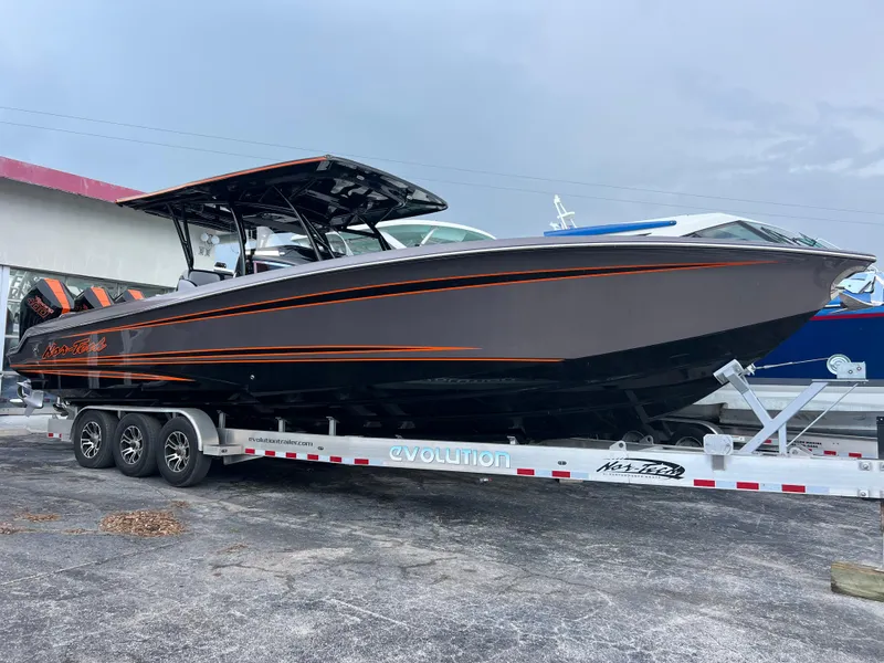 Slide: The Image of 2026 Nor-Tech 340 Sport boat on trailer, sleek design with orange accents. - 1