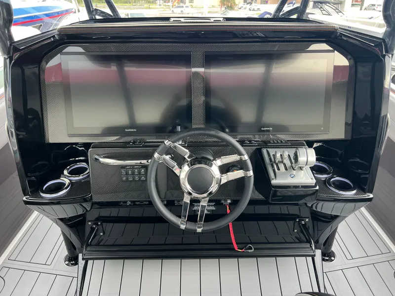 Slide: The Image of 2026 Nor-Tech 340 Sport dashboard with dual Garmin displays and sleek steering wheel. - 14