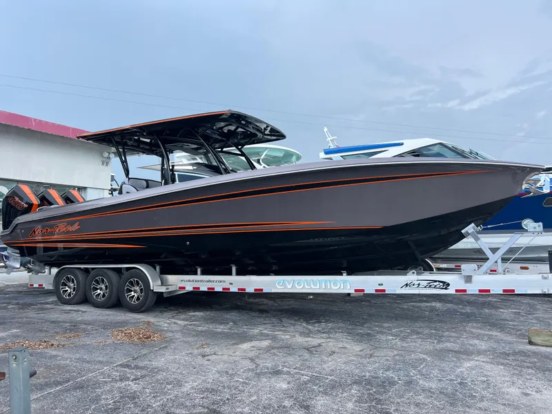 Slide: The Image of 2026 Nor-Tech 340 Sport boat on trailer, sleek design with orange accents. - 2