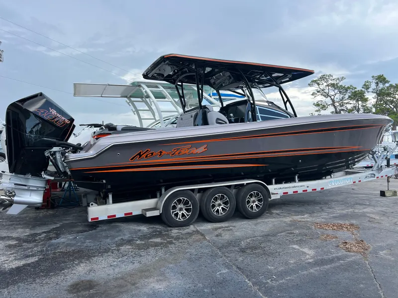 Slide: The Image of 2026 Nor-Tech 340 Sport boat on trailer, featuring sleek design and powerful engine. - 3
