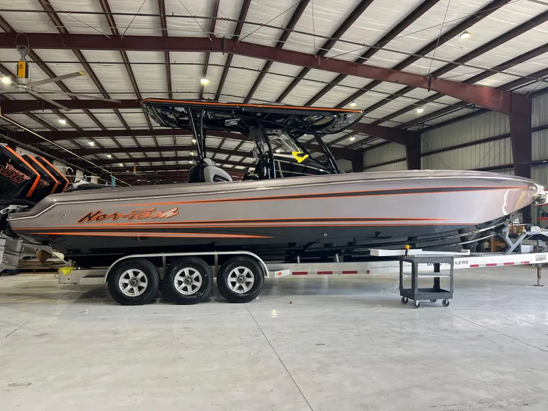 Slide: The Image of 2026 Nor-Tech 340 Sport boat in a warehouse, side view on a trailer. - 6