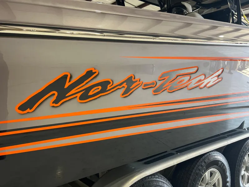 Slide: The Image of 2026 Nor-Tech 340 Sport boat with orange logo and stripes on the side. - 7