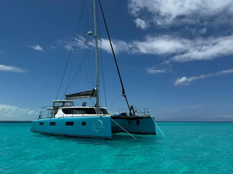 Slide: The Image of Vision 444 catamaran sailing in clear turquoise waters under a blue sky, 2025 model. - 12