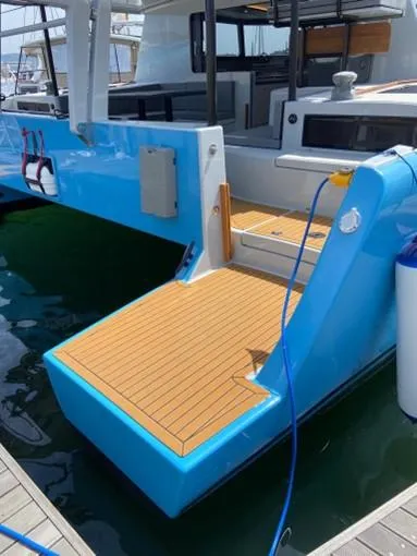 Slide: The Image of 2025 Vision 444 yacht with blue hull and teak deck at marina. - 34