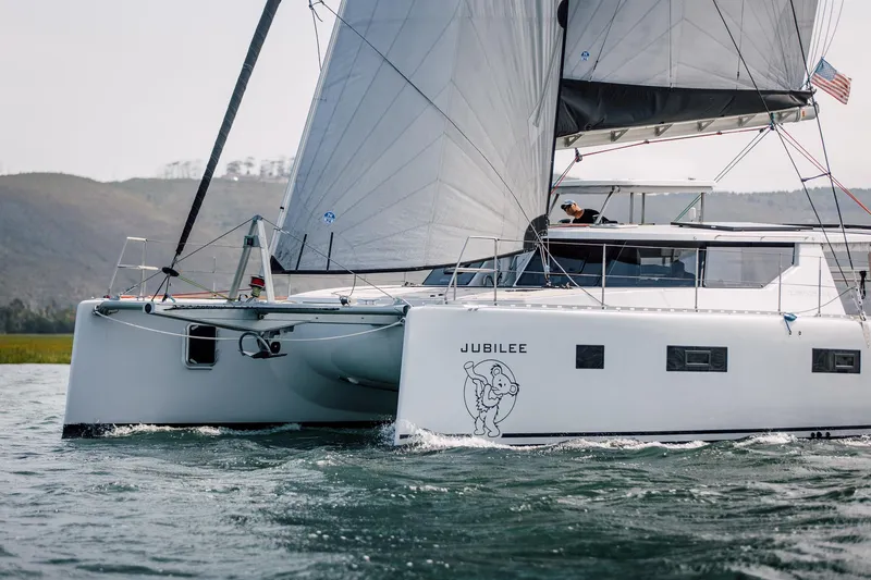 Slide: The Image of Modern Vision 444 catamaran Jubilee sailing on open water, 2025 model. - 4