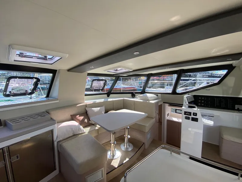 Slide: The Image of Vision 444 yacht interior, 2025 model, featuring modern seating, dining area, and panoramic windows. - 50