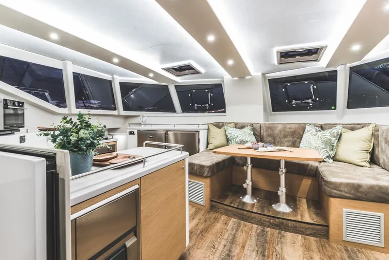 Slide: The Image of Luxurious Vision 444 yacht interior, featuring modern kitchen and cozy seating area, 2025 model. - 52