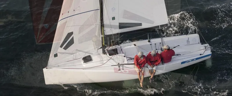 Slide: The Image of 2025 J Boats J/70 sailing with crew in red jackets on open water. - 3