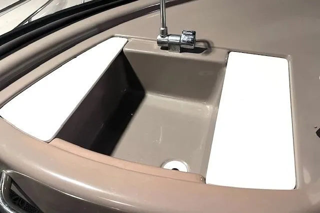 Slide: The Image of 1997 Carver 350 Mariner boat sink with faucet, beige and white design. - 12