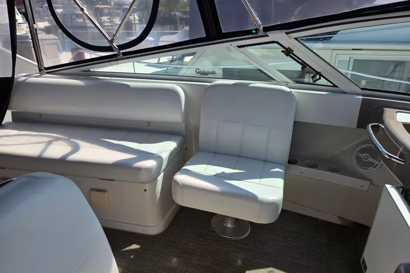 Slide: The Image of Interior of a 1997 Carver 350 Mariner boat with white seating and windows. - 15