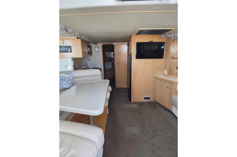 Slide: The Image of Interior of 1997 Carver 350 Mariner yacht with dining area and TV. - 27