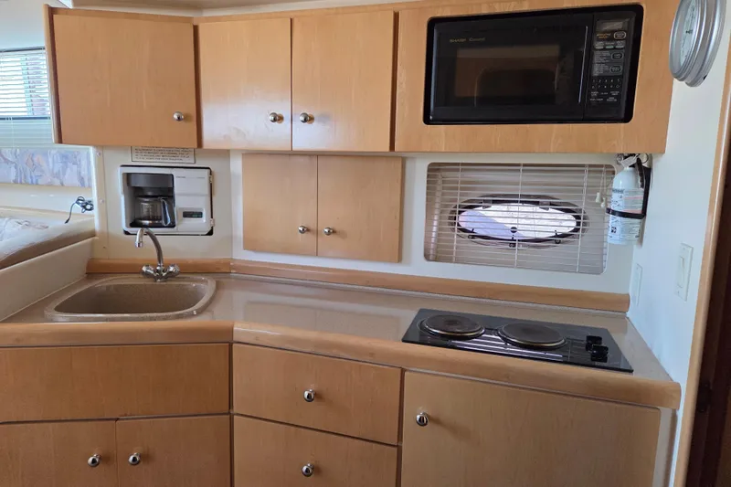 Slide: The Image of 1997 Carver 350 Mariner kitchen with sink, stove, microwave, and coffee maker. - 30