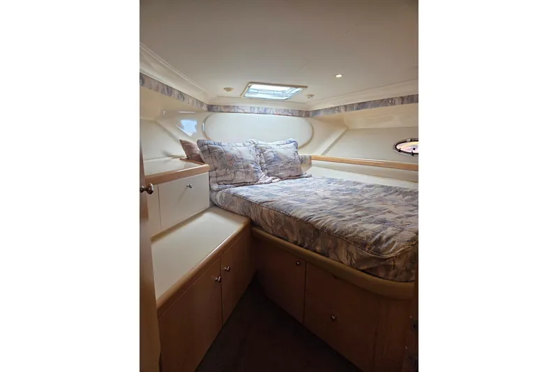 Slide: The Image of Cozy cabin interior of 1997 Carver 350 Mariner with bed and storage. - 32
