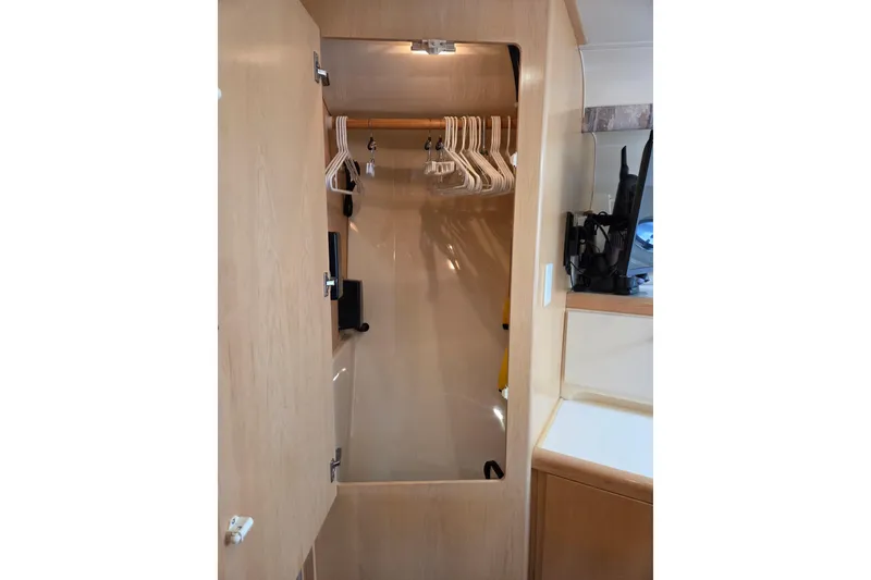 Slide: The Image of Interior closet of 1997 Carver 350 Mariner yacht with hangers and storage space. - 34